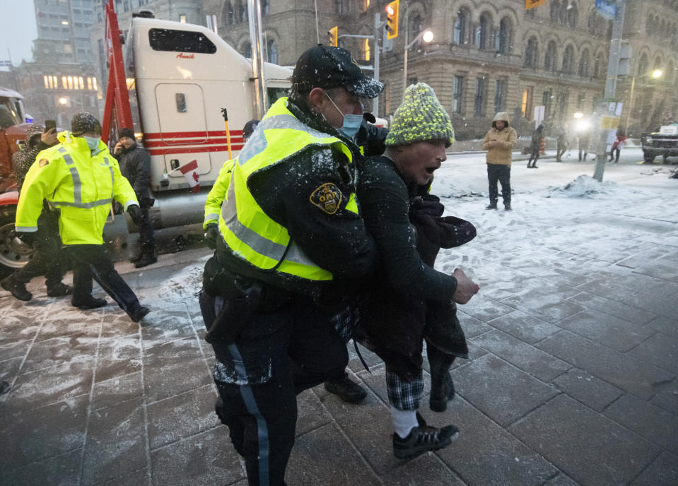 Police make an arrest after a person interfered with a police operation, during an ongoing against COVID-19 measures that has grown into a broader anti-government protest, in Ottawa, Ontario, on Thursday, Feb. 17, 2022. (Justin Tang/The Canadian Press via AP)