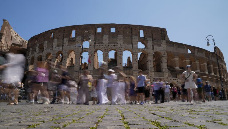 Visitors walk past the Colosseum, in Rome, Tuesday, June 27, 2023. Italy’s culture and tourism ministers Gennaro Sangiuliano vowed to find and punish a tourist who was filmed carving his name and his girlfriend’s name in the wall of the Colosseum, a crime that in the past has resulted in hefty fines.