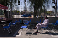 FILE - In this April 28, 2021, file photo, Lashauna Gipson sits in the observation area after receiving the Johnson & Johnson's COVID-19 vaccine at a Cedars-Sinai sponsored pop-up vaccine clinic at the Watts-Willowbrook Boys & Girls Club in Los Angeles. States across the country are dramatically scaling back their COVID-19 vaccine orders as interest in the shots wanes, putting the goal of herd immunity further out of reach. (AP Photo/Jae C. Hong, File)