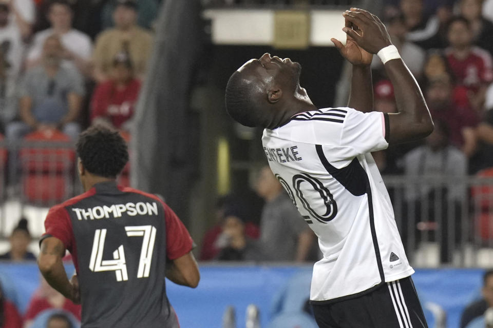 D.C. United Christian Benteke, right, reacts after a missed goal-scoring opportunity during second-half MLS soccer match action against Toronto FC in Toronto, Ontario, Saturday, May 27, 2023. (Chris Young/The Canadian Press via AP)