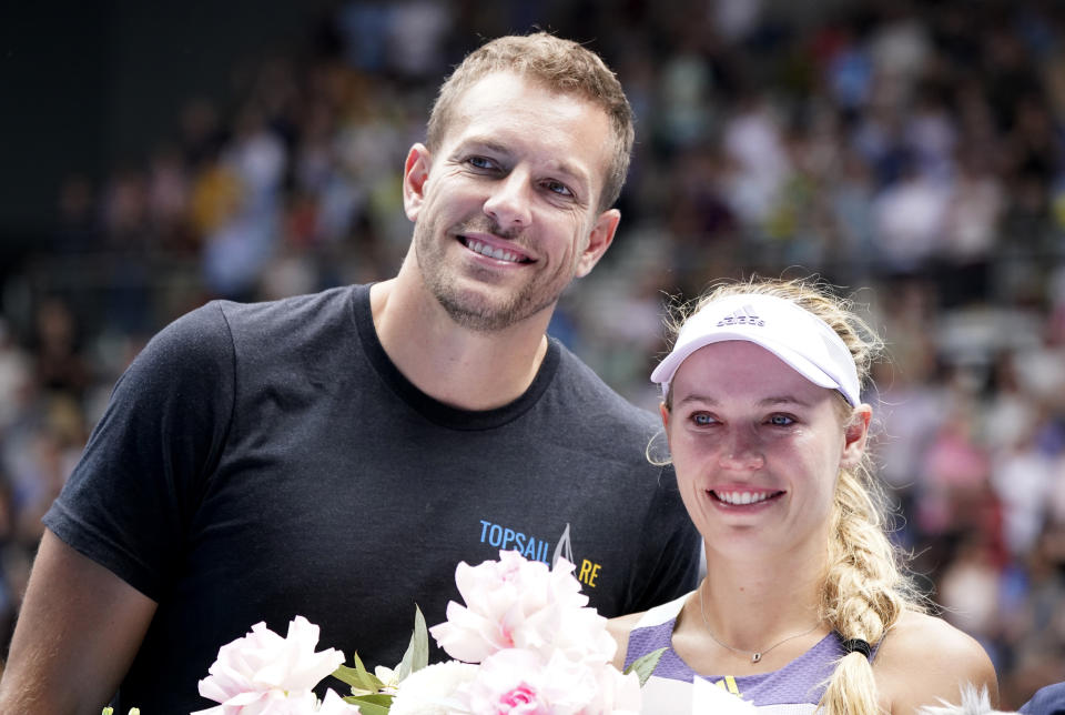 Tennis - Australian Open - Third Round - Melbourne Park, Melbourne, Australia - January 24, 2020 - Denmark’s Caroline Wozniacki poses with her husband David Lee as she heads into retirement after losing the match against Tunisia’s Ons Jabeur. REUTERS/Kim Hong-Ji