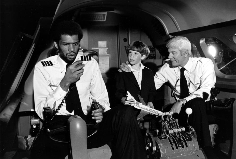 NBA legend Kareem Abdul-Jabbar (left, with Peter Graves at far right) has some of the funniest scenes in the 1980 comedy classic "Airplane!"