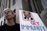 Protestors gather before the arrival of the Trump Organization's former Chief Financial Officer Allen Weisselberg at court, Friday, Aug. 12, 2022, in New York. (AP Photo/John Minchillo)