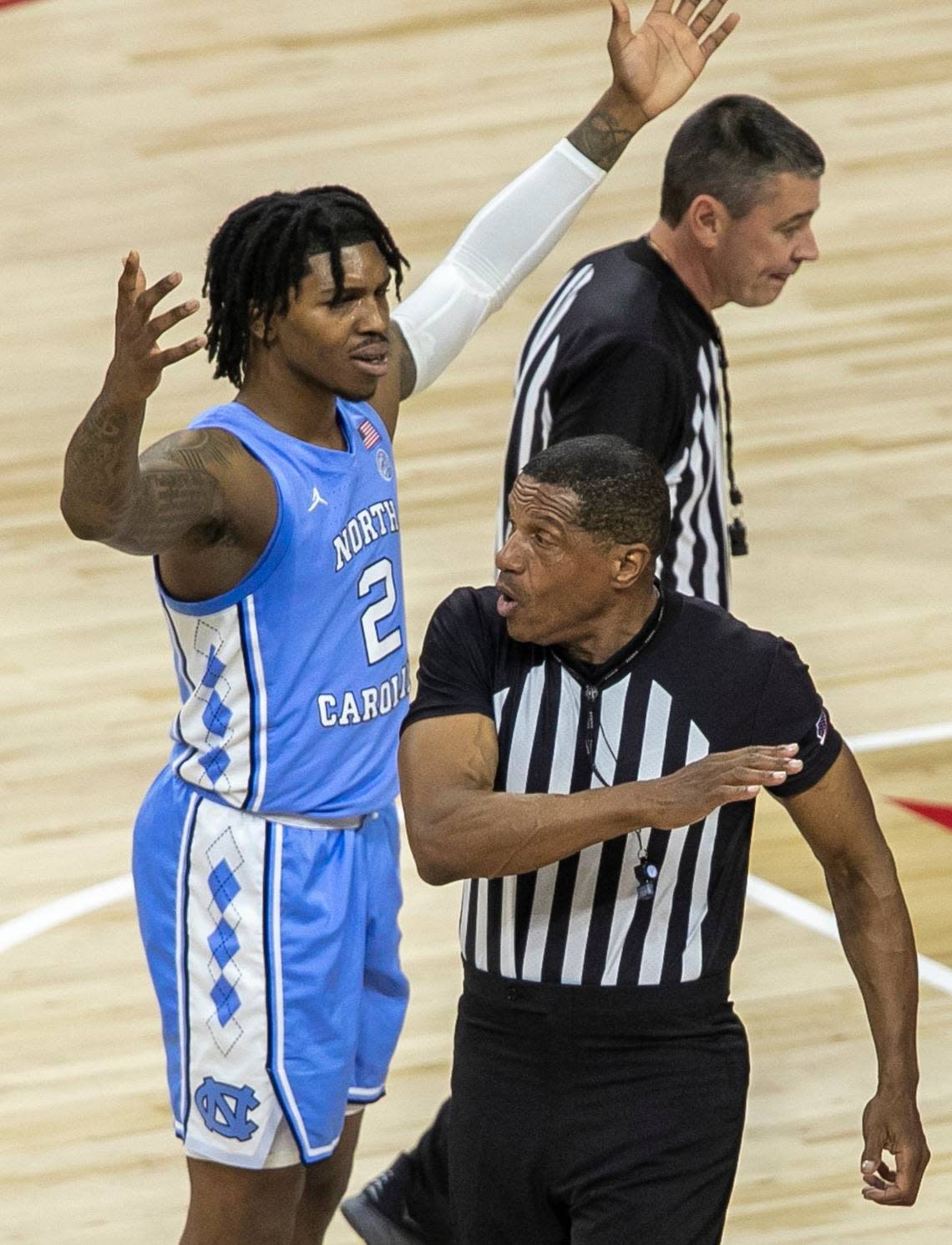 North Carolina’s Caleb Love (2) reacts a foul call by official Ted Valentine during the first half against N.C. State on Sunday, February 19, 2023 at PNC Arena in Raleigh, N.C.