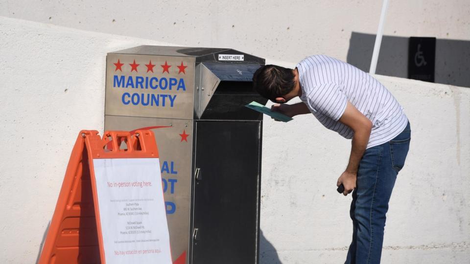 PHOTO: In this Oct. 18, 2020 file photo, a person is seen depositing their mail-in ballots for the U.S. presidential election at a ballot collection box in Phoenix. (Robyn Beck/AFP via Getty Images, FILE)