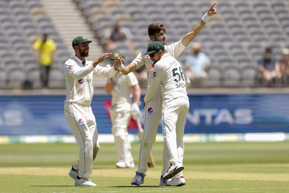 Shaheen Shah Afridi of Pakistan is congratulated by teammates after dismissing Usman Khawaja of Australia during play on the first day of the first cricket test between Australia and Pakistan in Perth, Australia, Thursday, Dec. 14, 2023. (Richard Wainwright/AAP Image via AP)