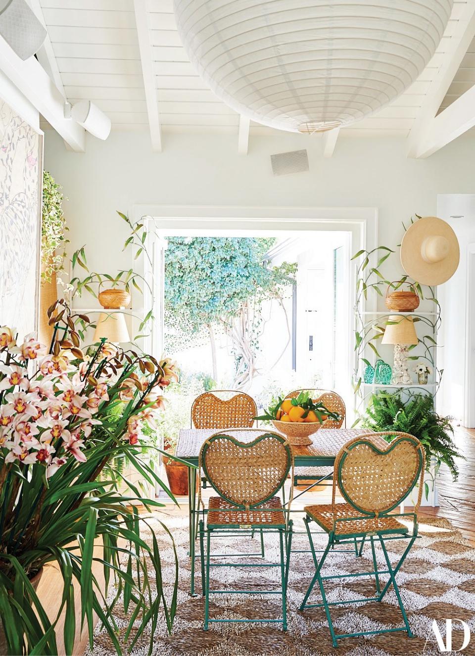 An antique wicker dining set from Pat McGann gallery anchors the dining area.