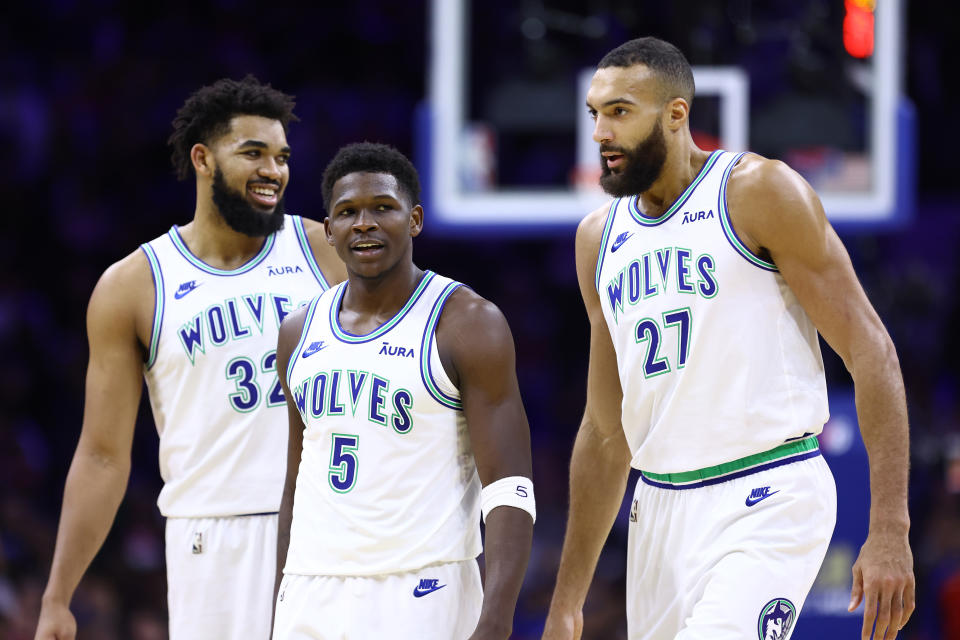 PHILADELPHIA, PENNSYLVANIA - DECEMBER 20: Anthony Edwards #5 of the Minnesota Timberwolves looks on between teammates Karl-Anthony Towns #32 and Rudy Gobert #27 during the second quarter against the Philadelphia 76ers at the Wells Fargo Center on December 20, 2023 in Philadelphia, Pennsylvania. NOTE TO USER: User expressly acknowledges and agrees that, by downloading and or using this photograph, User is consenting to the terms and conditions of the Getty Images License Agreement. (Photo by Tim Nwachukwu/Getty Images)