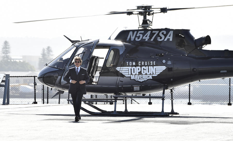 Tom Cruise walks to the red carpet after riding a helicopter to the world premiere of 