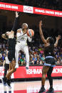 Dallas Wings guard Arike Ogunbowale (24) looks to shoot from between Chicago Sky guard Marina Mabrey, left, and guard Dana Evans during the first half of a WNBA basketball game Wednesday, May 15, 2024, in Arlington, Texas. (AP Photo/Brandon Wade)