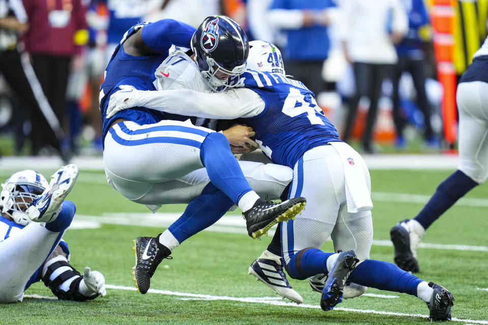 Tennessee Titans quarterback Ryan Tannehill is sacked by Indianapolis Colts defensive end Kwity Paye, left, and Zaire Franklin in the second half of an NFL football game in Indianapolis, Fla., Sunday, Oct. 2, 2022. (AP Photo/AJ Mast)