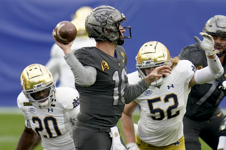 Notre Dame linebacker Bo Bauer (52) and safety Shaun Crawford (20) pressurer Pittsburgh quarterback Joey Yellen (16) during the first half of an NCAA college football game, Saturday, Oct. 24, 2020, in Pittsburgh. (AP Photo/Keith Srakocic)