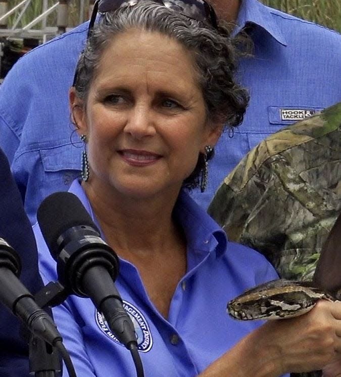 Jacqui Thurlow-Lippisch of Sewall's Point, a member of the South Florida Water Management District board, holds the head of a python in Fort Lauderdale in August 2019.