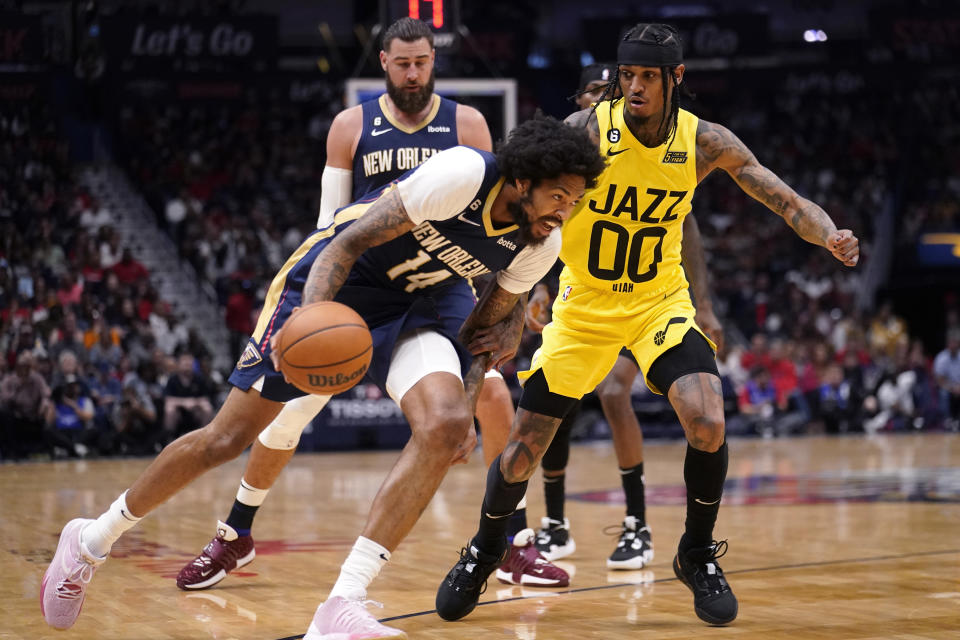 New Orleans Pelicans forward Brandon Ingram (14) drives to the basket against Utah Jazz guard Jordan Clarkson (00) in the first half of an NBA basketball game in New Orleans, Sunday, Oct. 23, 2022. (AP Photo/Gerald Herbert)