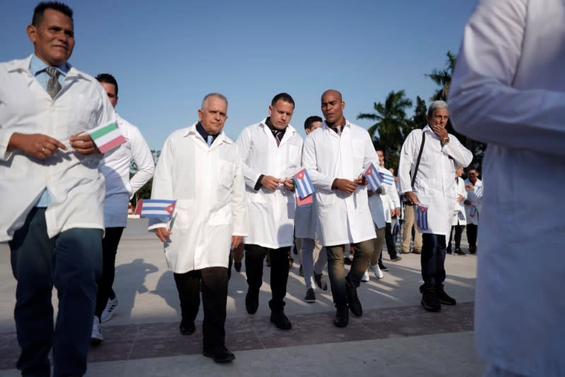 Cuban doctors take part in a farewell ceremony before departing to Italy to assist, amid concerns about the spread of the coronavirus disease outbreak