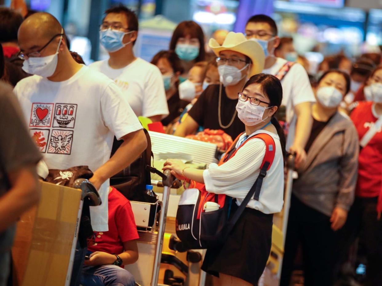 Chinese tourists wearing protective masks wait in line at Don Mueang airport in Bangkok, Thailand: EPA