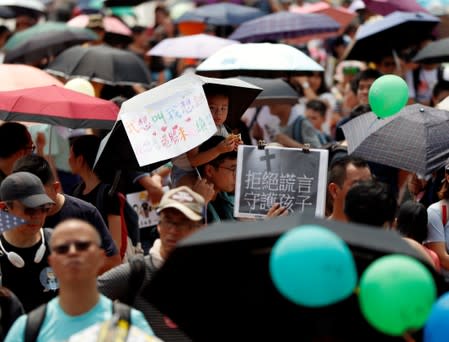 Family members participate in a protest rally titled "Guard Our Children's Future" at Edinburgh Place in Hong Kong, China