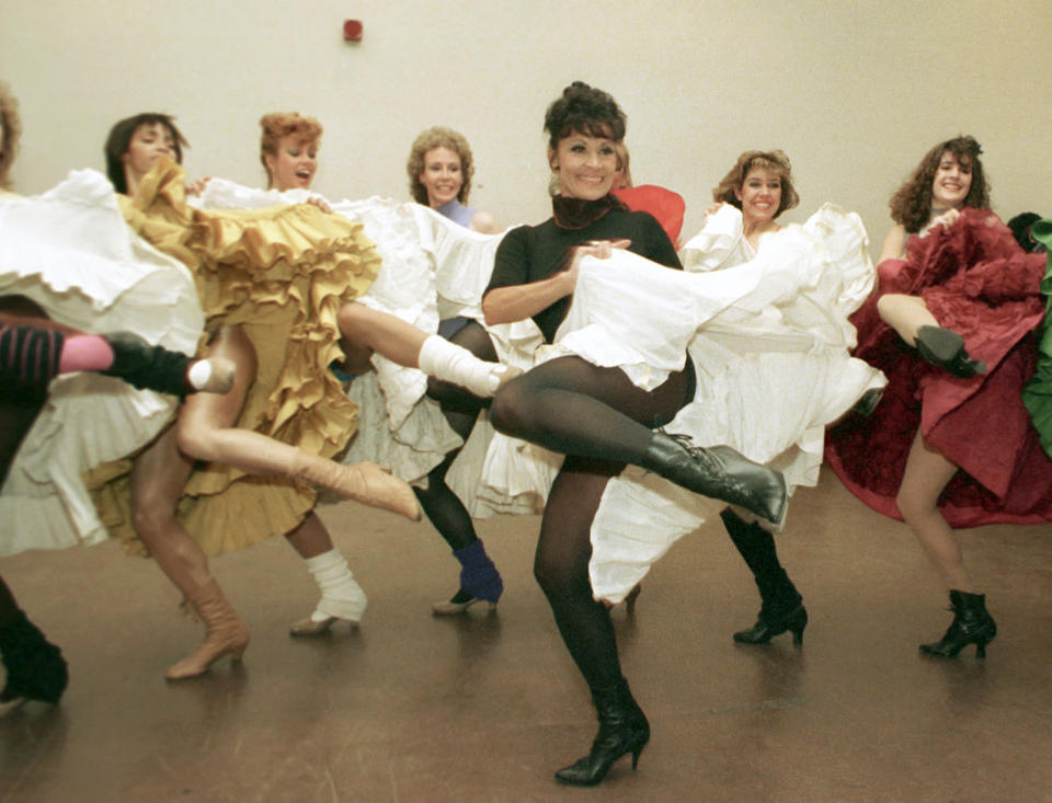 FILE - Broadway star Chita Rivera, foreground, and the Radio City Music Hall Rockettes rehearse Cole Porter's "Can Can" in New York on Jan. 21, 1988. Rivera, the dynamic dancer, singer and actress who garnered 10 Tony nominations, winning twice, in a long Broadway career that forged a path for Latina artists, died Tuesday. She was 91. (AP Photo/Marty Lederhandler, File)