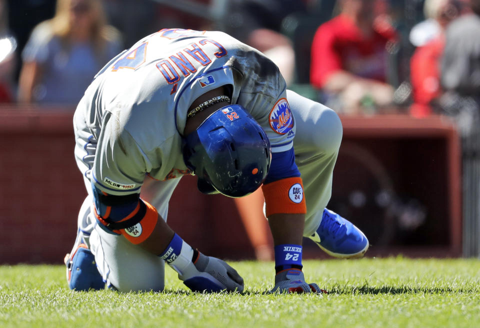 New York Mets' Robinson Cano doubles over after being injured while batting during the seventh inning of a baseball game against the St. Louis Cardinals Sunday, April 21, 2019, in St. Louis. (AP Photo/Jeff Roberson)