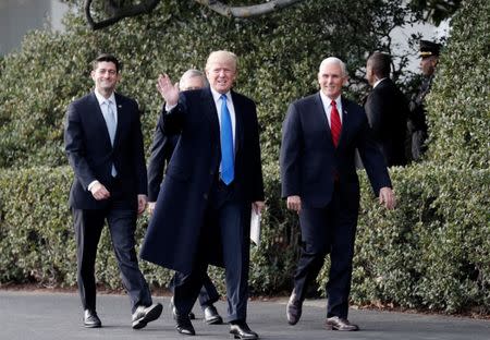 FILE PHOTO: U.S. President Donald Trump arrives with Vice President Mike Pence and House Speaker Paul Ryan prior to celebrating with Congressional Republicans after the U.S. Congress passed sweeping tax overhaul legislation on the South Lawn of the White House in Washington, U.S., December 20, 2017. REUTERS/Carlos Barria/File Photo