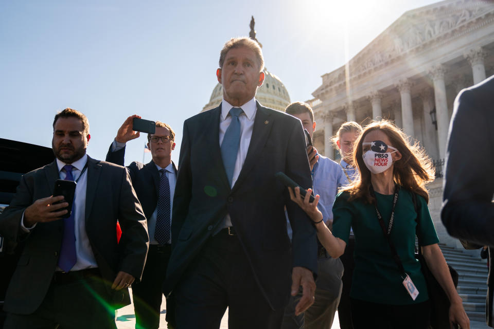 Sen. Joe Manchin, D-W.Va., surrounded by reporters outside the Capitol. (Kent Nishimura/Los Angeles Times via Getty Images)