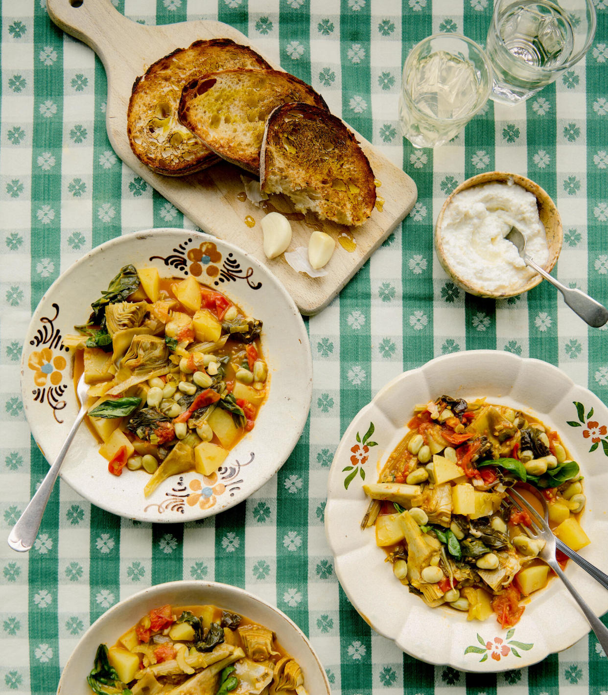 <span>Rachel Roddy’s <em>scafata</em>, or spring vegetable stew, with seasoned ricotta and garlic and oil toasts.</span><span>Photograph: Kim Lightbody/The Guardian. Food styling: Hanna Miller. Prop styling: Louie Waller. Food styling assistant: Alice Earll.</span>