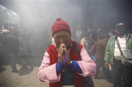 Mother of Ankaji Sherpa, who lost his life in an avalanche at Mount Everest last Friday, pays final tribute to her son during the cremation ceremony of Nepali Sherpa climbers in Kathmandu April 21, 2014. REUTERS/Navesh Chitrakar