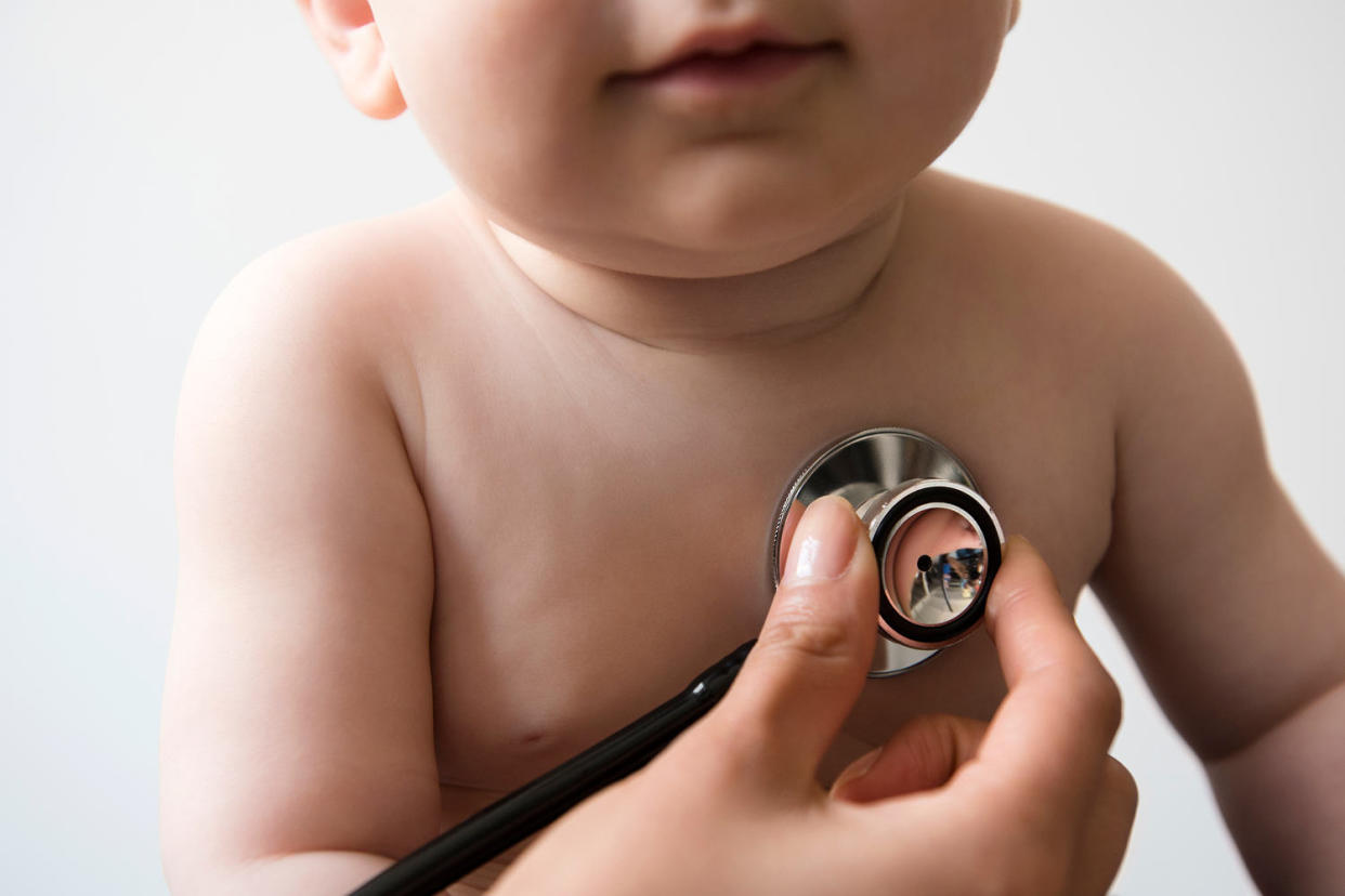 Doctor listening to chest of baby boy with stethoscope (JGI/Jamie Grill / Getty Images/Tetra images RF)