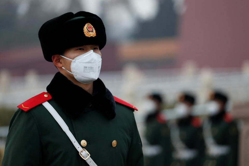 A paramilitary officer wearing a face masks stands guard at the Tiananmen Gate, as the country is hit by an outbreak of the new coronavirus, in Beijing, China January 27, 2020. REUTERS/Carlos Garcia Rawlins