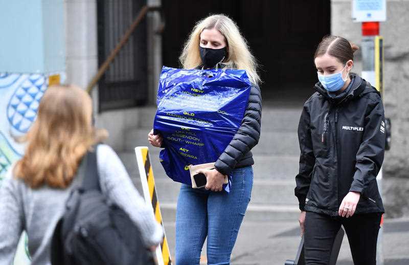 People are seen wearing protective face masks during lockdown in Brisbane.