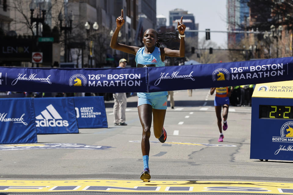Peres Jepchirchir, of Kenya, crosses the finish line to win the women's division of the 126th Boston Marathon, Monday, April 18, 2022, in Boston. (AP Photo/Winslow Townson)