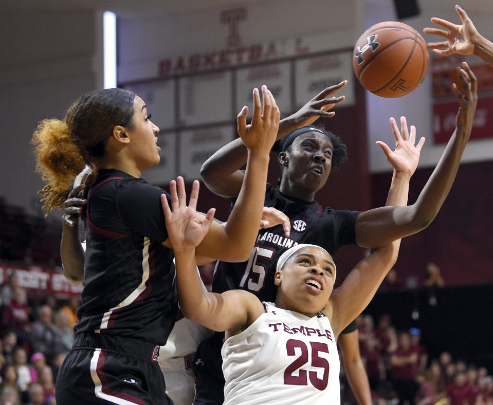 Temple's Mia Davis (25) battles for position against South Carolina's Breanna Beal, left, and Laeticia Amihere during the second half of an NCAA college basketball game, Saturday, Dec. 7, 2019, in Philadelphia. (AP Photo/Derik Hamilton)