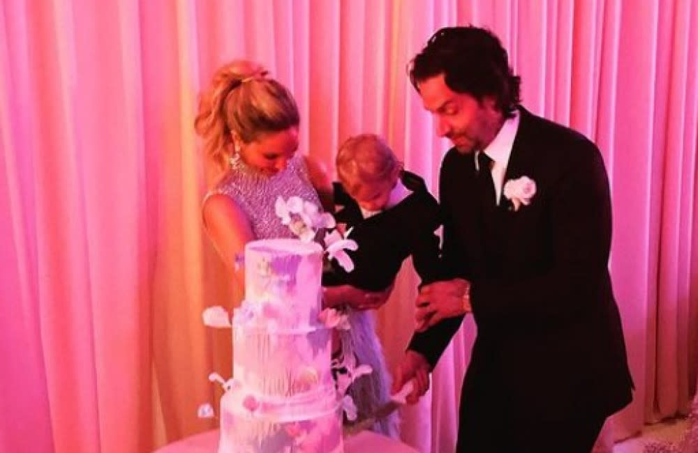 Kristin Taylor and Chris D'Elia cut their wedding cake (c) Instagram credit:Bang Showbiz
