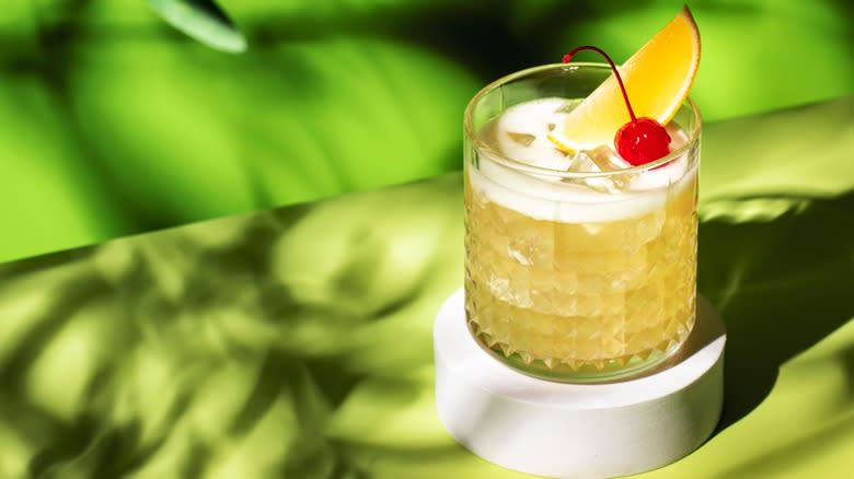 whiskey sour against green background