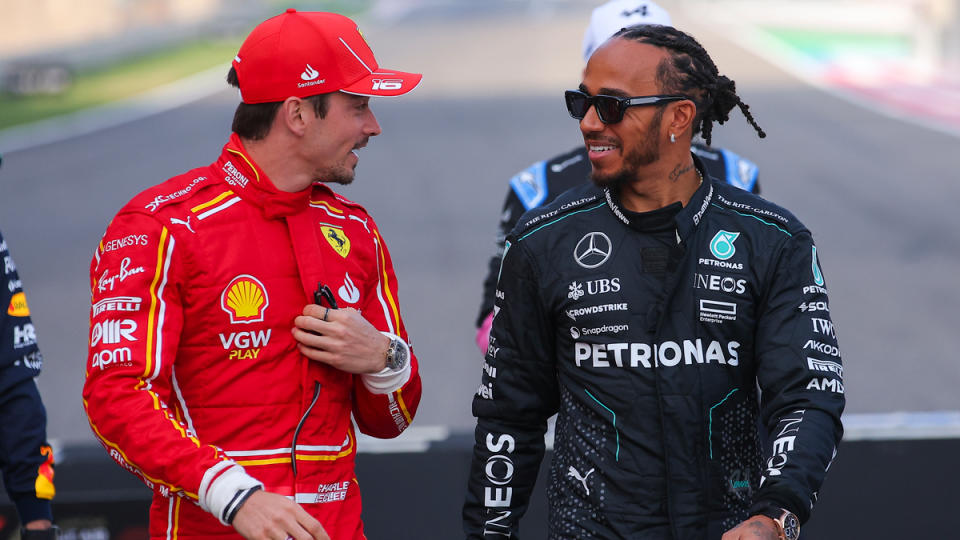 Mercedes-AMG's Lewis Hamilton (right) and Ferrari's Charles Leclerc share a light moment before Formula 1's 2024 Bahrain Grand Prix.