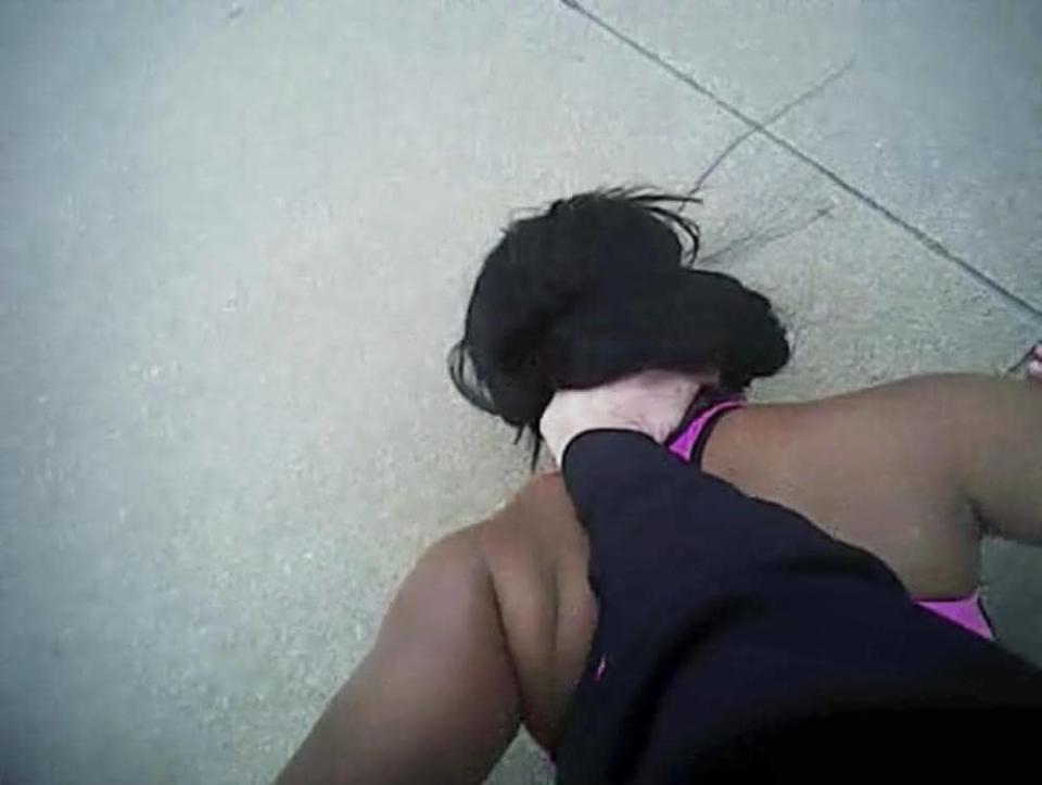 In this image obtained from Fort Worth Police Officer William Martin’s body camera footage, Dec. 21, 2016, Martin holds Jacqueline Craig’s daughter down in Fort Worth, Texas. (Fort Worth Police Department via AP, File)