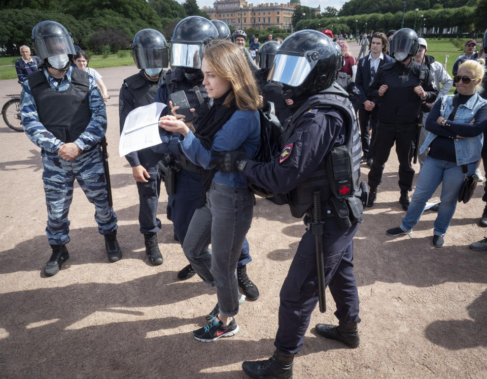 Police detain a protester during a rally supporting Khabarovsk region's governor Sergei Furgal in St.Petersburg, Russia, Saturday, Aug. 1, 2020. Thousands of demonstrators rallied Saturday in the Russian Far East city of Khabarovsk to protest the arrest of the regional governor, continuing a three-week wave of opposition that has challenged the Kremlin. (AP Photo/Dmitri Lovetsky)