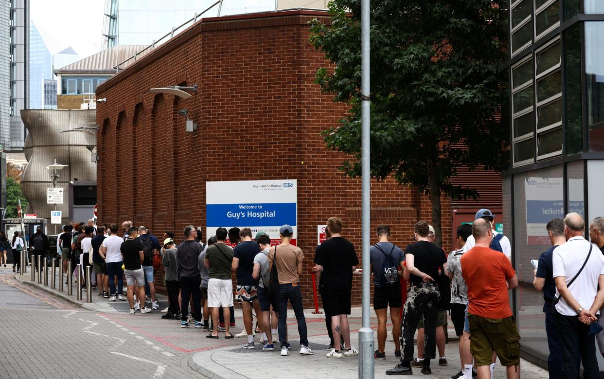 People queue up to receive monkeypox vaccinations during a pop-up clinic at Guy's Hospital in central London, Britain, July 30, 2022