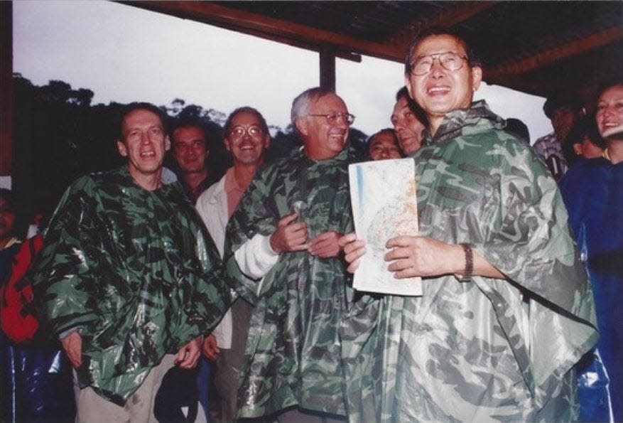 Dennis Jett, left, with Peru's then-President Alberto Fujimori, right, visiting a development project in the 1990s.