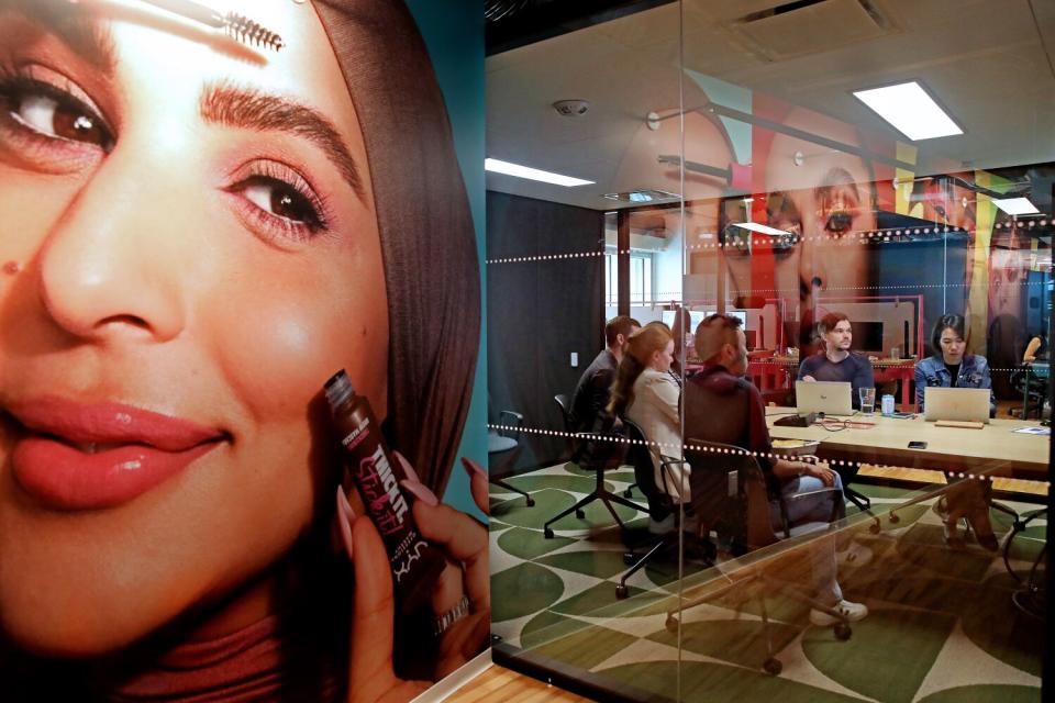 Workers meet in a collaboration room at L'Oréal's office.