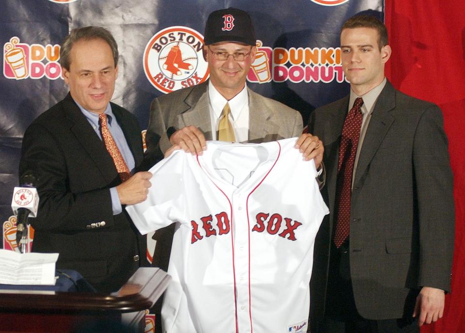 BOSTON, MA - DECEMBER 4:  Larry Lucchino, CEO of the Boston Red Sox (L) and  Red Sox General Manager Theo Epstein (R) stand next to Terry Francona after he was named the Red Sox 44th manager in club history at a Fenway Park December 4, 2003 in Boston, Massachusetts. Francona, who had once managed for the Phillies, will replace Grady Little who was not rehired.  (Photo by Jessica Rinaldi/Getty Images)