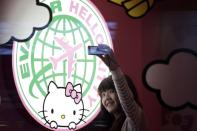 A passenger takes a self-portrait with an Eva Airlines' Hello Kitty-themed light box in Taoyuan International Airport, northern Taiwan.