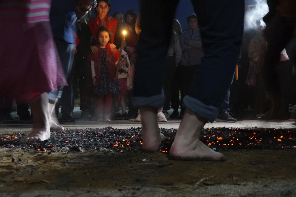 Firewalkers dance across a bed of burning coals in a ritual in honor of St. Constantine in the village of Lagkadas, Greece on Monday, May 22, 2023. Firewalking is the most spectacular and public of these annual rituals that also include dancing with icons, prayer, and shared meals by associations of devotees of the Christian Orthodox saint called "anastenaria" that have held similar celebrations for centuries. (AP Photo/Giovanna Dell'Orto)