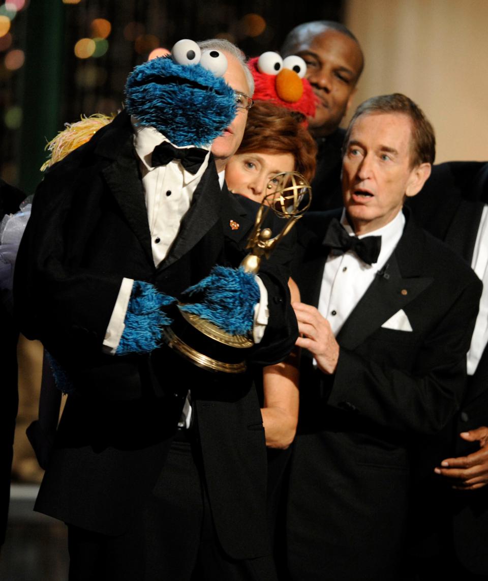 Bob McGrath, right, looks at the Cookie Monster as they accept the Lifetime Achievement Award for "Sesame Street" at the Daytime Emmy Awards in 2009.