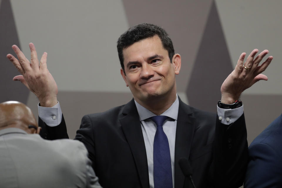 FILE - Brazil's Justice Minister Sergio Moro throws his hands up as he arrives to testify before a Senate commission, in Brasilia, Brazil, Wednesday, June 19, 2019. When Moro resigned to enter politics, many in Brazil believed the anti-corruption crusader who jailed da Silva could someday occupy the nation’s most powerful office. But on the eve of Brazil’s Oct. 2, 2022 general election, the once-revered magistrate was fighting what polls showed was a losing battle for a Senate seat. (AP Photo/Eraldo Peres, File)