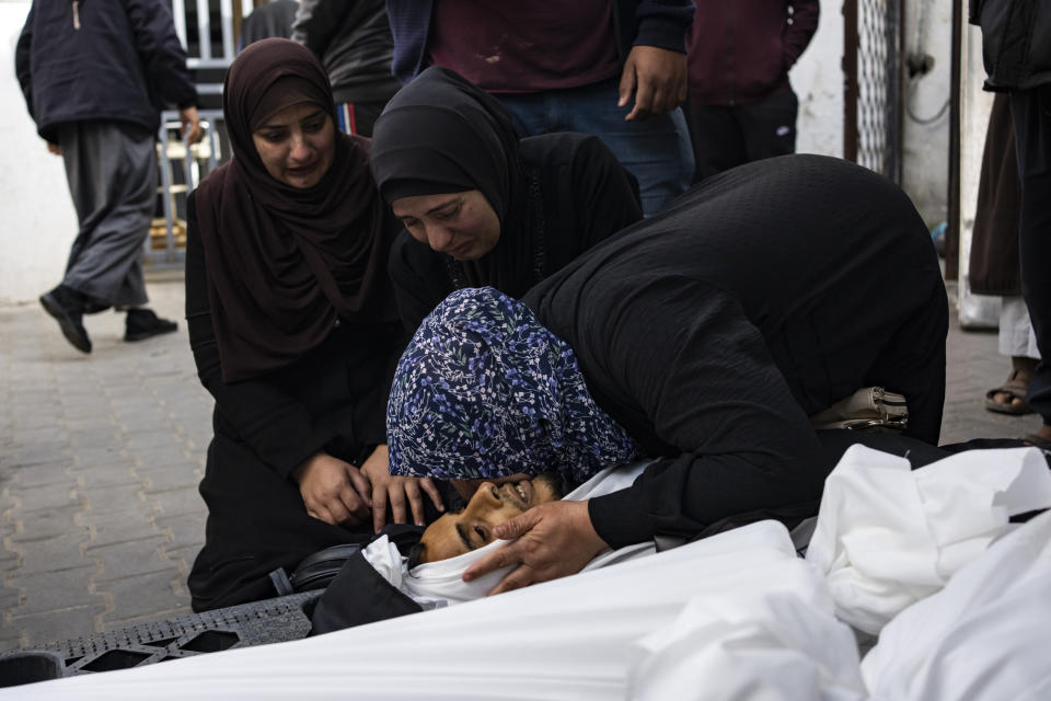 Palestinians mourn relatives killed in the Israeli bombardment of the Gaza Strip at a hospital morgue in Rafah, Tuesday, March 26, 2024. (AP Photo/Fatima Shbair)