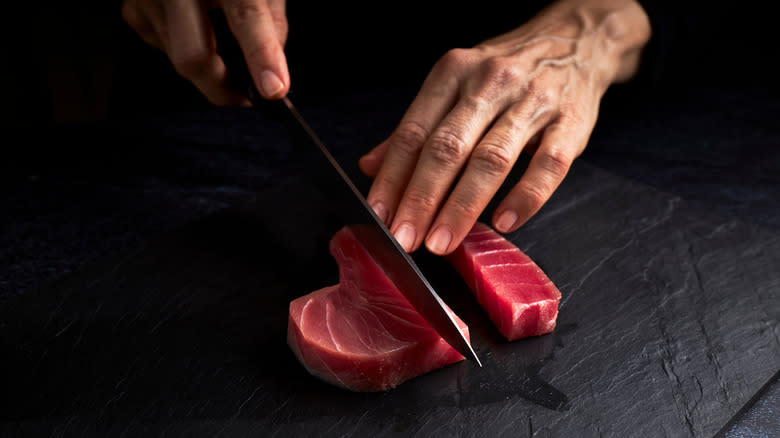 Slicing bluefin tuna on table