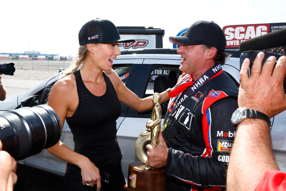 LAS VEGAS, NV - APRIL 16: Tony Stewart (314 TA) Mobil 1 McPhillips Racing Top Alcohol Dragster is congratulated by his wife, Leah Pruett (777 TF) Dodge Power Brokers NHRA Top Fuel Dragster, after winning his class at the NHRA Four-Wide Nationals Camping World Drag Racing Series on April 16, 2023 at The Strip at Las Vegas Motor Speedway in Las Vegas, Nevada. This was Stewart's first NHRA win and marked the fourth track he has won a race at Las Vegas Motor Speedway: The Bullring, The Dirt Track, the Speedway, and the drag strip. (Photo by Jeff Speer/Icon Sportswire via Getty Images)