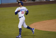 Los Angeles Dodgers' Mookie Betts turns to the dugout after scoring a double steal during the first inning of the team's baseball game against the Los Angeles Angels on Friday, Sept. 25, 2020, in Los Angeles. (AP Photo/Ashley Landis)