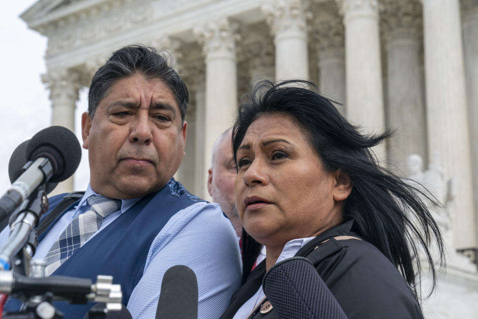 Beatriz Gonzalez, right, the mother of 23-year-old Nohemi Gonzalez, a student killed in the Paris terrorist attacks, and stepfather Jose Hernandez, speak outside the Supreme Court,Tuesday, Feb. 21, 2023, in Washington. A lawsuit against YouTube from the family of Nohemi Gonzalez was argued at the Supreme Court. (AP Photo/Alex Brandon)